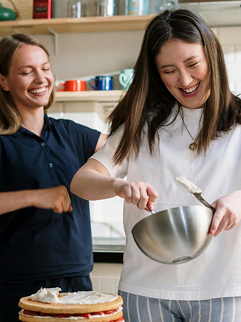 two friends in kitchen baking